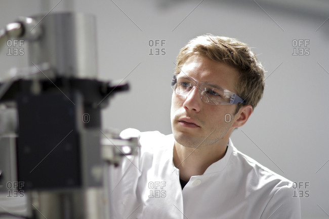 Portrait of scientist working at spectrometer in analytical laboratory