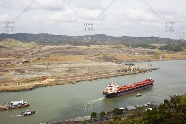 Cruise ship travelling thru the Pedro Miguel Locks at the Panama Canal with construction of the new Canal Expansion evident in the background