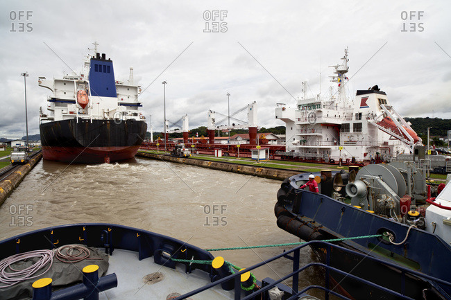 Crew member on bow of tugboat observing the transit of the Miraflores Locks, Panama Canal