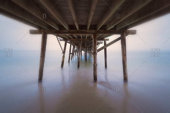 View under a pier in foggy weather
