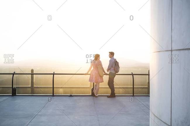 Rear view of couple standing and watching the landscape