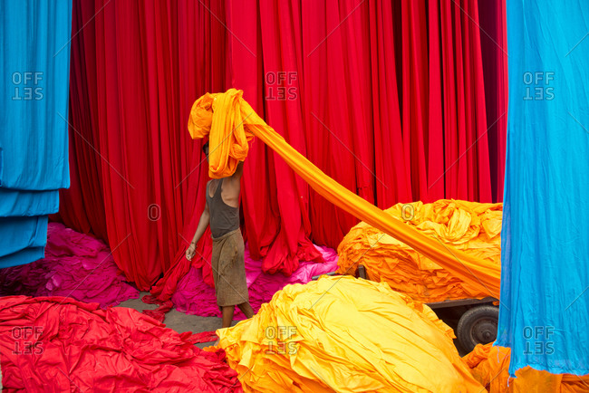 Worker at a dyed cloth factory in Rajasthan, India.