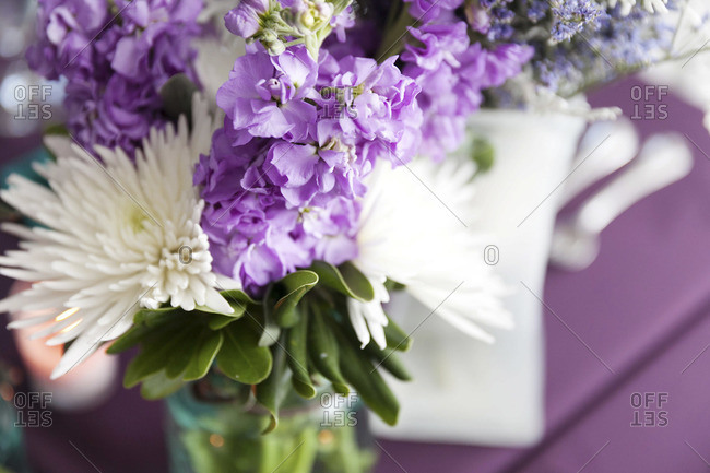 Purple and white flower bouquet at wedding venue