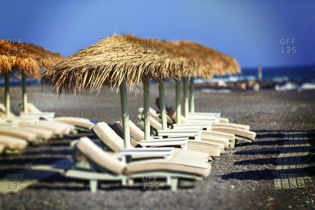 Sun loungers and parasols on an empty beach