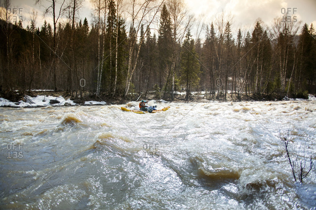 People rafting on a wavy river