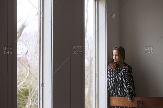 Woman staring out of a window
