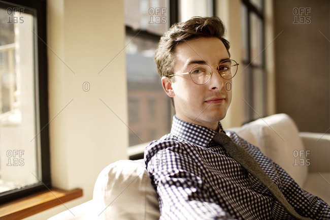 Young businessman on office couch