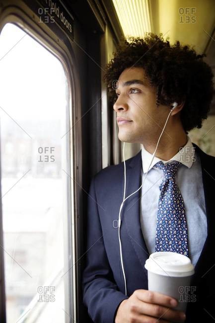 Businessman looking out subway window