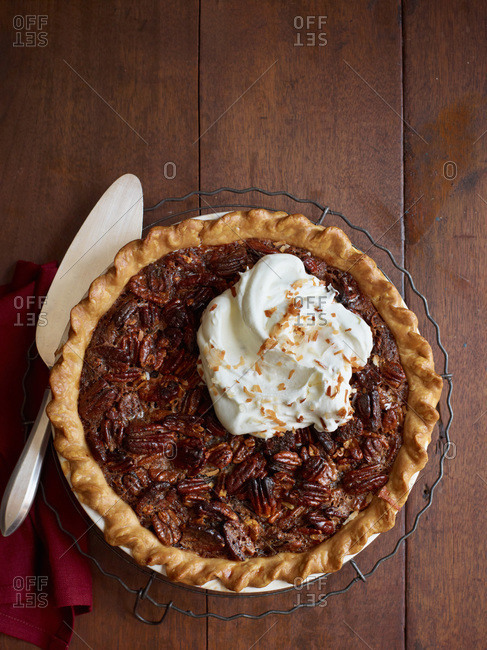 Coconut chocolate pecan pie served with whipped cream