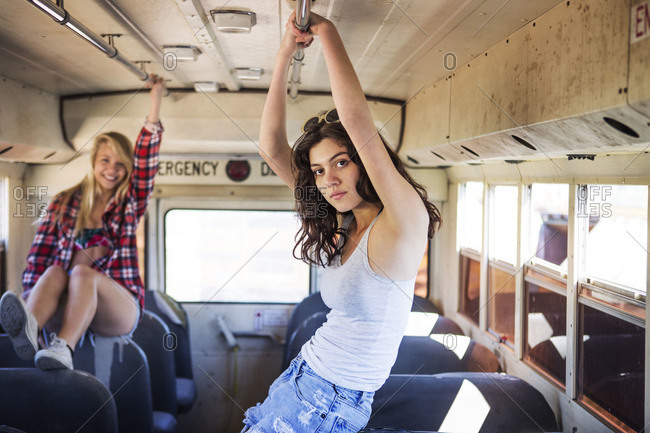 Two young women hanging out on a bus