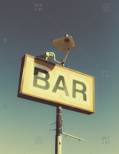 A faded BAR sign on the roadside