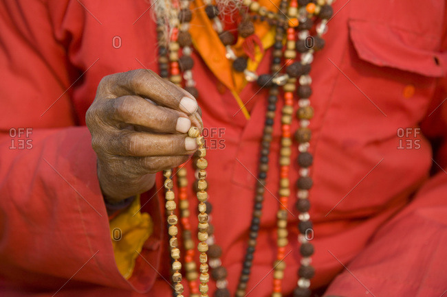 Hindu holy man with beads at Kumbh Mela festival, India