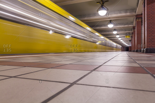 Subway station Rathaus Reinickendorf with moving underground train, Berlin, Germany