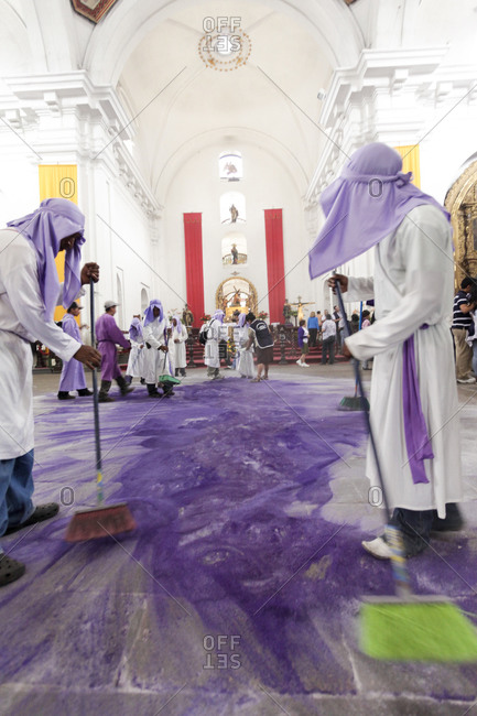 Man sweeping the floor of La Merced Church at the Holy week procession in Antigua, Guatemala