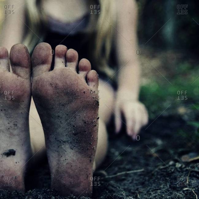 Close up of a child\'s dirty feet