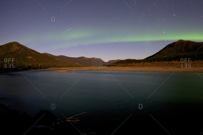An asteroid shoots through the sky as the northern lights dance in north Alaska.