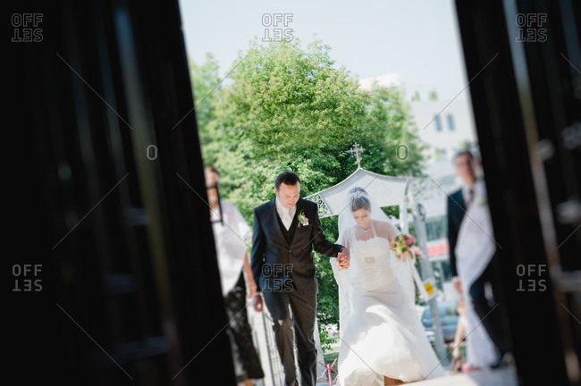 Couple entering a chapel together on their wedding day