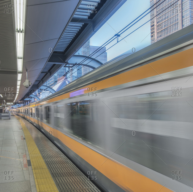 Blurred view of train leaving platform, Tokyo, Japan