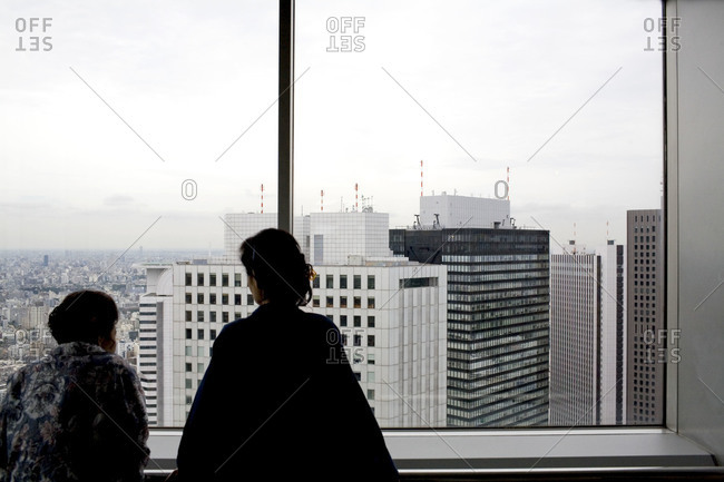 Women looking out of an observation deck in Tokyo, Japan