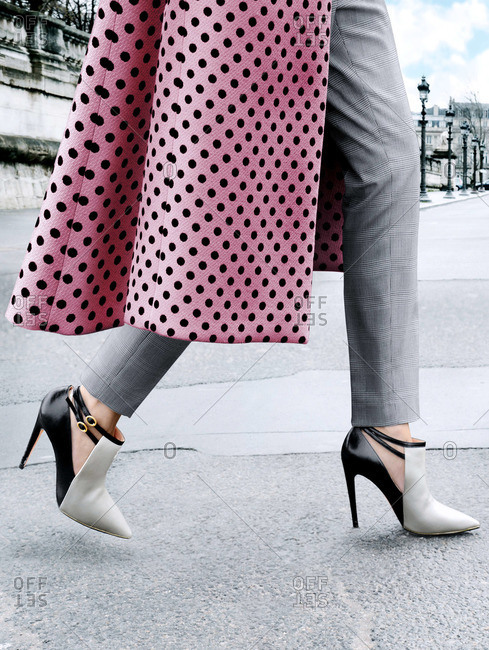 Close up of woman walking in high-heeled shoes