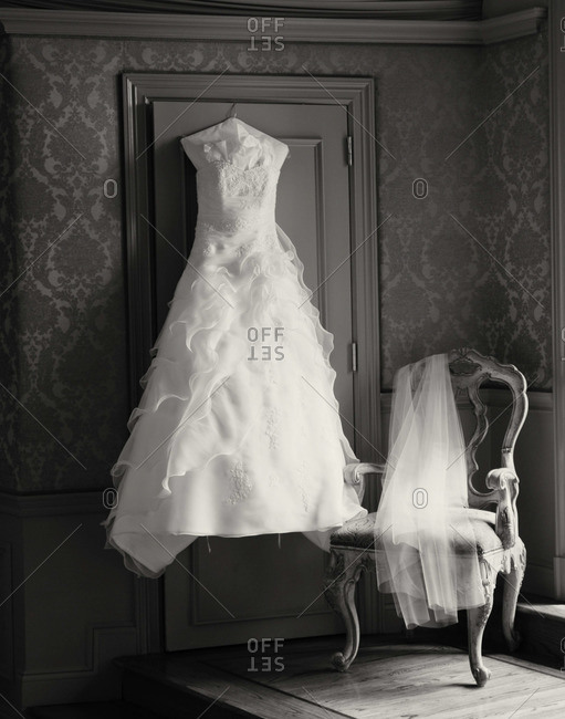 Frilly wedding dress on a hanger