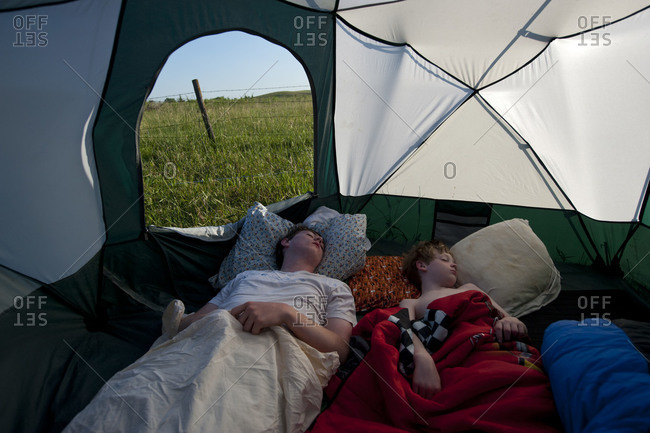 Two brothers sleep during a camping trip
