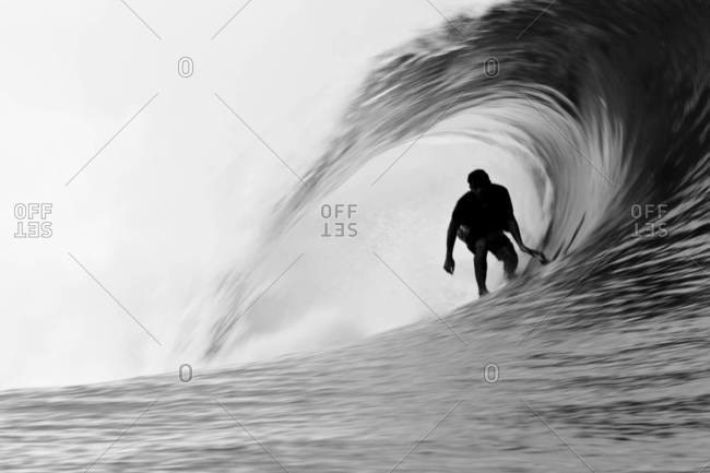 Surfer inside a perfect tube, Tahiti