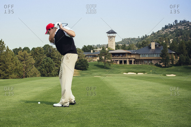 Golfer teeing off at a golf course