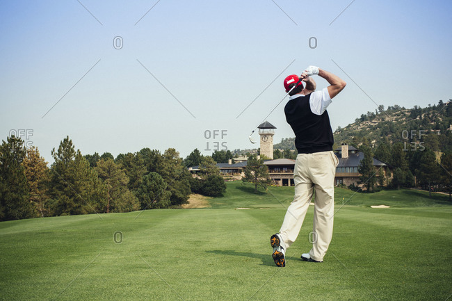 Man teeing off at a golf course
