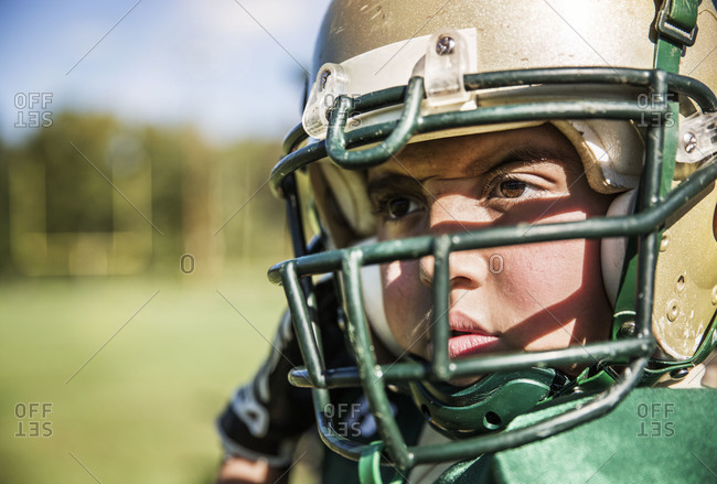 Close-up of boy in football helmet