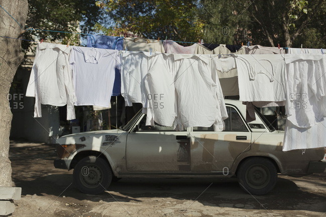 Car parking behind drying clothes in Baku, Azerbaijan