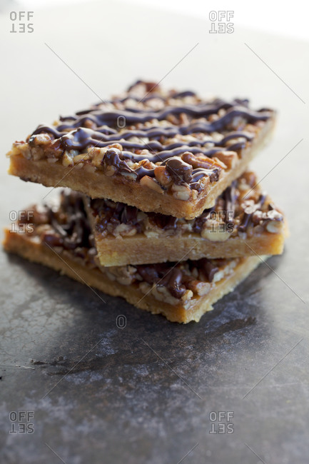 Three granola bars drizzled with melted chocolate