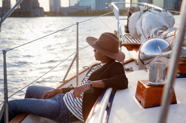 Man in hat lounging on boat