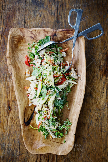 Warm chicken salad with peppers, pears and toasted pine nuts