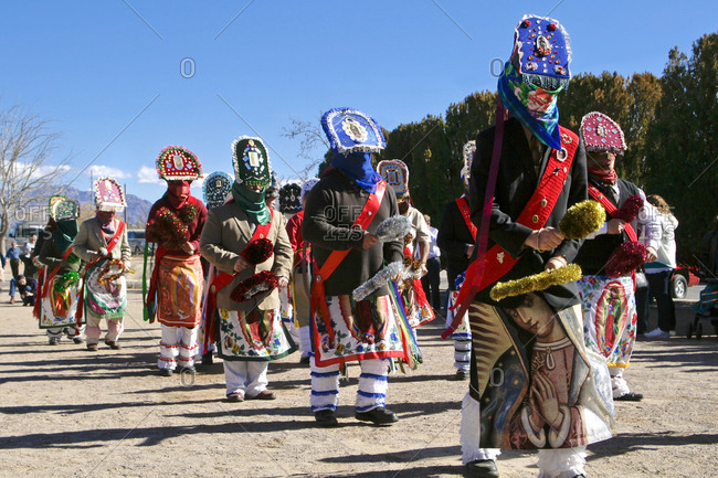 Traditional Chichimeca dancers at the celebration of Virgin Guadalupe in Tortugas Pueblo, New Mexico, USA