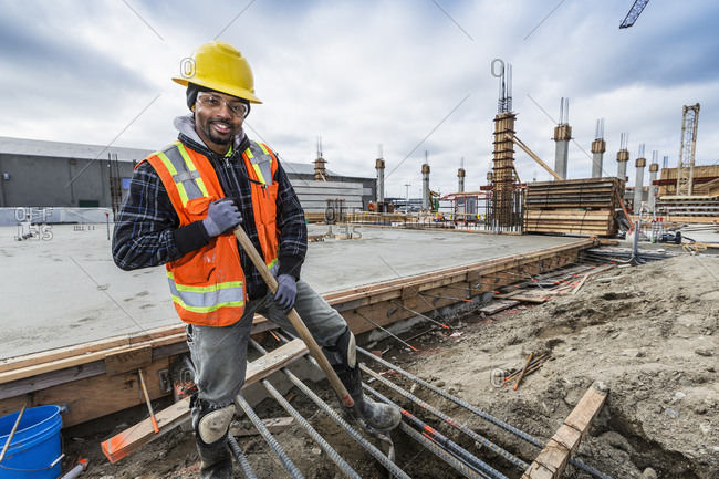 Black worker smiling at construction site