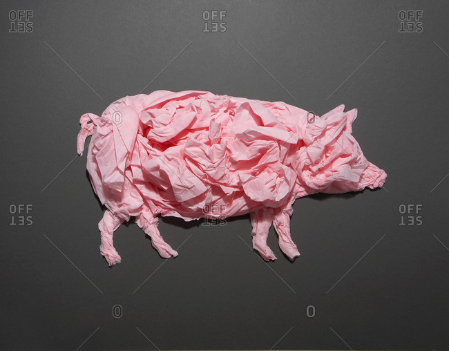 Crumpled pink tissue paper forms a pig
