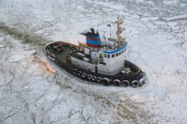 Tug boat breaking the ice in Helsinki, Finland