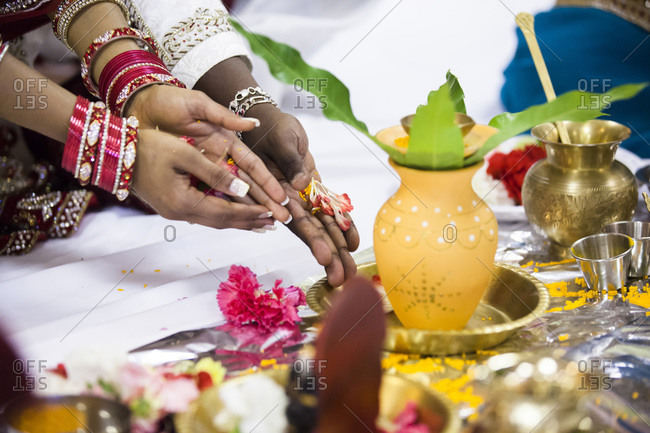 Close-up of bride and groom\'s hands at Hindu wedding ceremony, Toronto, Ontario, Canada