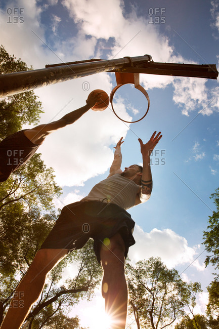 Man jumping to slam dunk a basketball