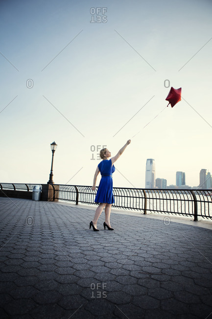 Woman letting go of a balloon