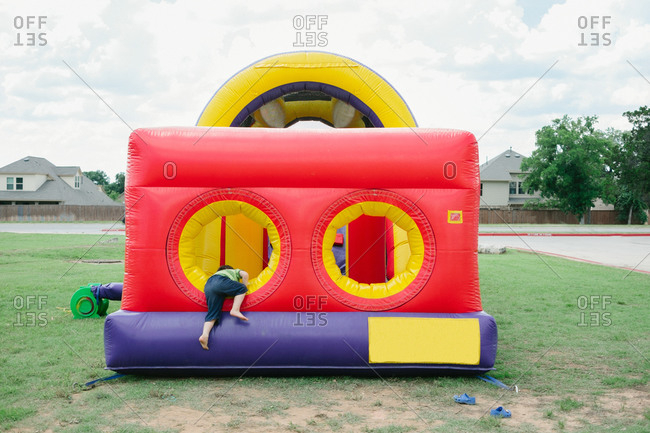 Boy climbing in a bouncy castle