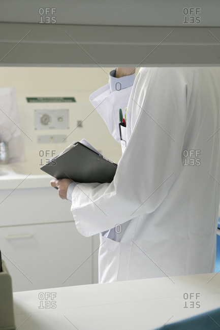 Mid-section of Doctor holding medical record