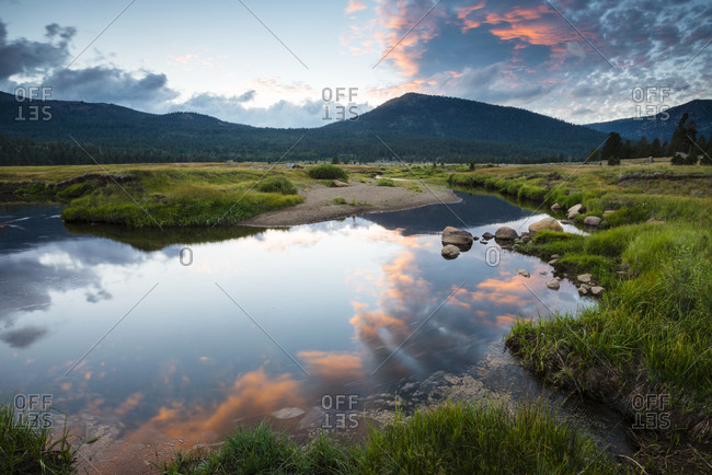 Carson River reflects the beautiful clouds overhead at sunset in Hope Valley, California