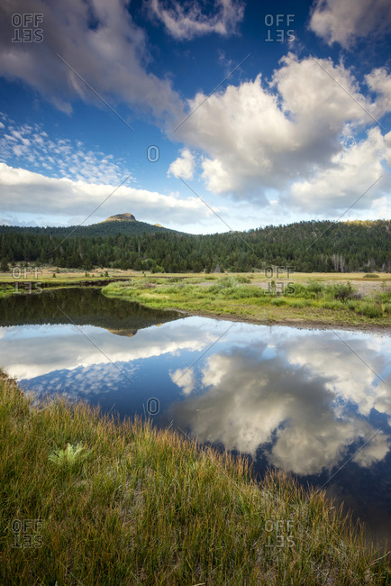 The still water of the West Fork of the Carson River reflects the beautiful clouds overhead in Hope Valley, California