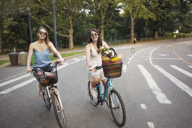 Two girls riding their bikes in Central Park