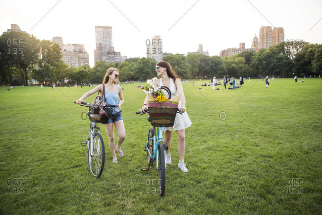 Same-sex couple pushing their bikes in Central Park