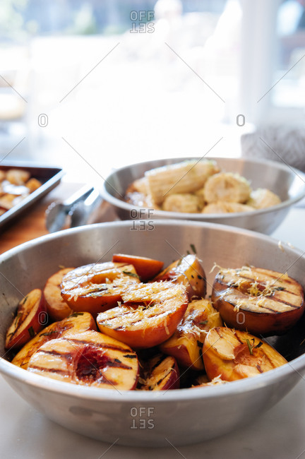 Grilled peaches seasoned with lemon zest and champagne vinegar