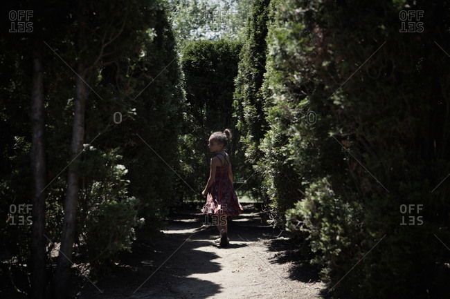 Young girl walking in maze