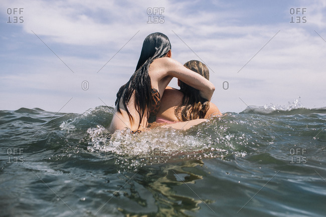 Young women wrestling in water